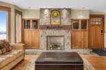 This stunning living room boasts a beautiful stone fireplace, creating a cozy and inviting atmosphere.