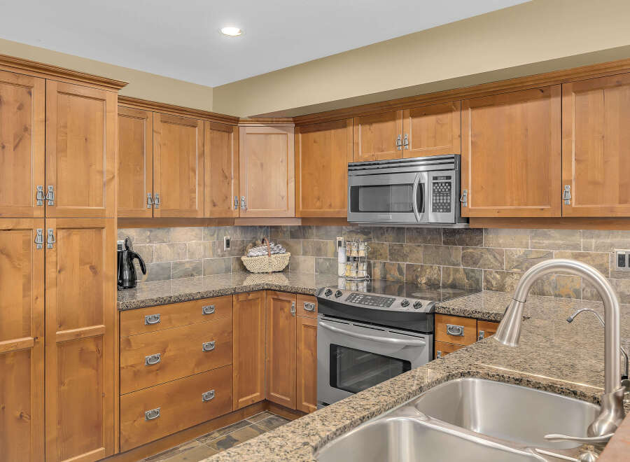 This stunning kitchen boasts beautiful wooden cabinetry, offering ample storage space and a warm, inviting atmosphere.