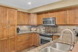 This stunning kitchen boasts beautiful wooden cabinetry, offering ample storage space and a warm, inviting atmosphere.