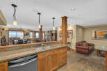 This stunning kitchen boasts a beautiful granite countertop, stainless steel sink, and modern appliances.