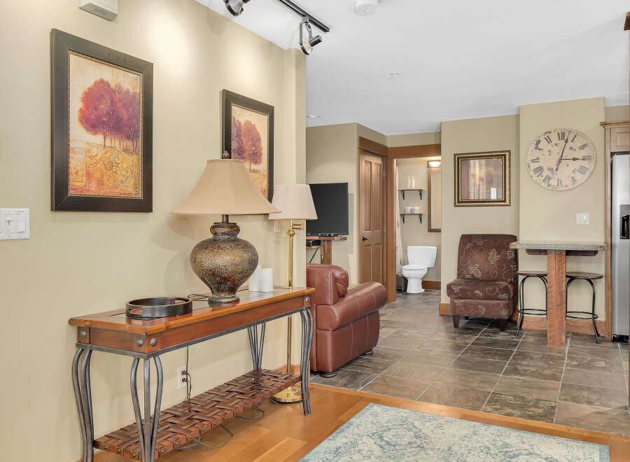 Step into this inviting living space, featuring a warm color palette and stylish decor.