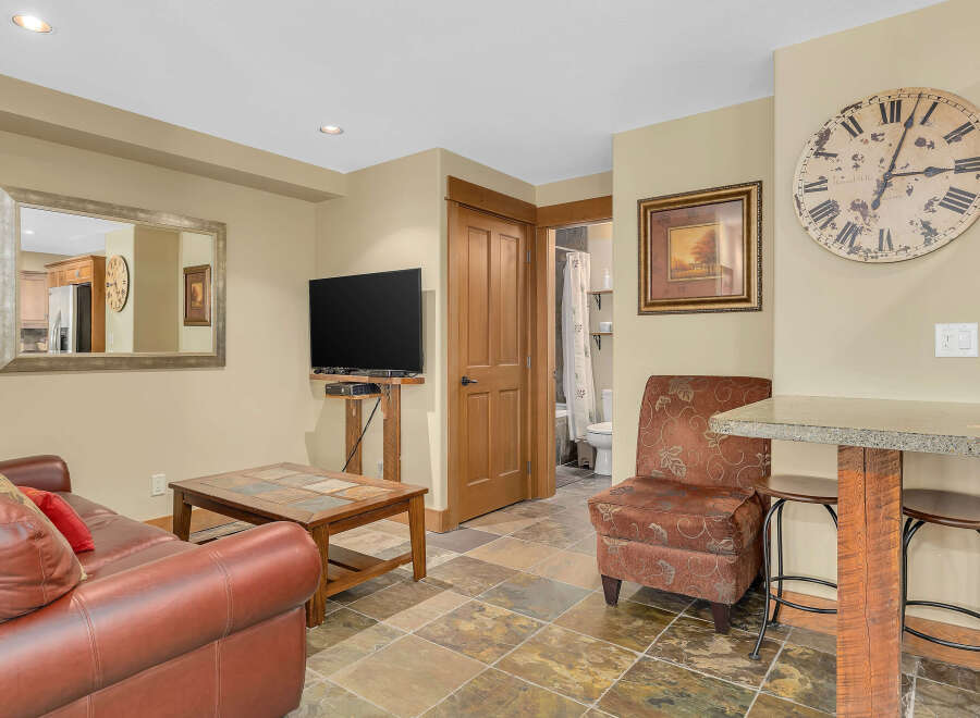 This cozy living space features a comfortable leather sofa, perfect for relaxing.