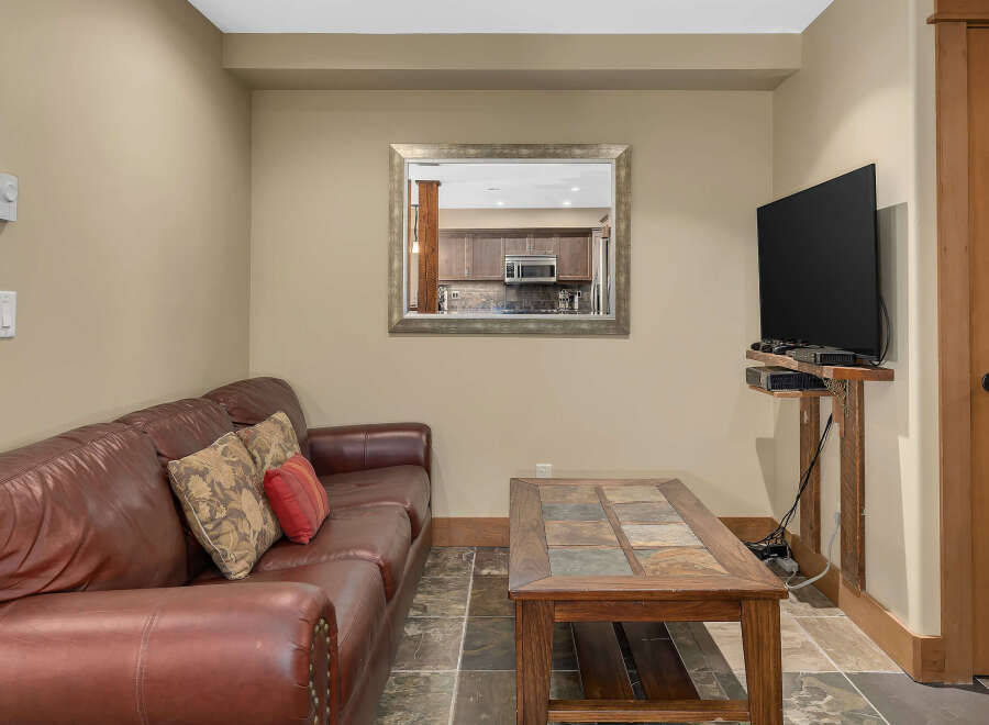 This cozy living space features a comfortable leather sofa, perfect for relaxing.