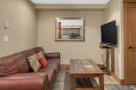 This cozy living space features a comfortable leather sofa, perfect for relaxing.