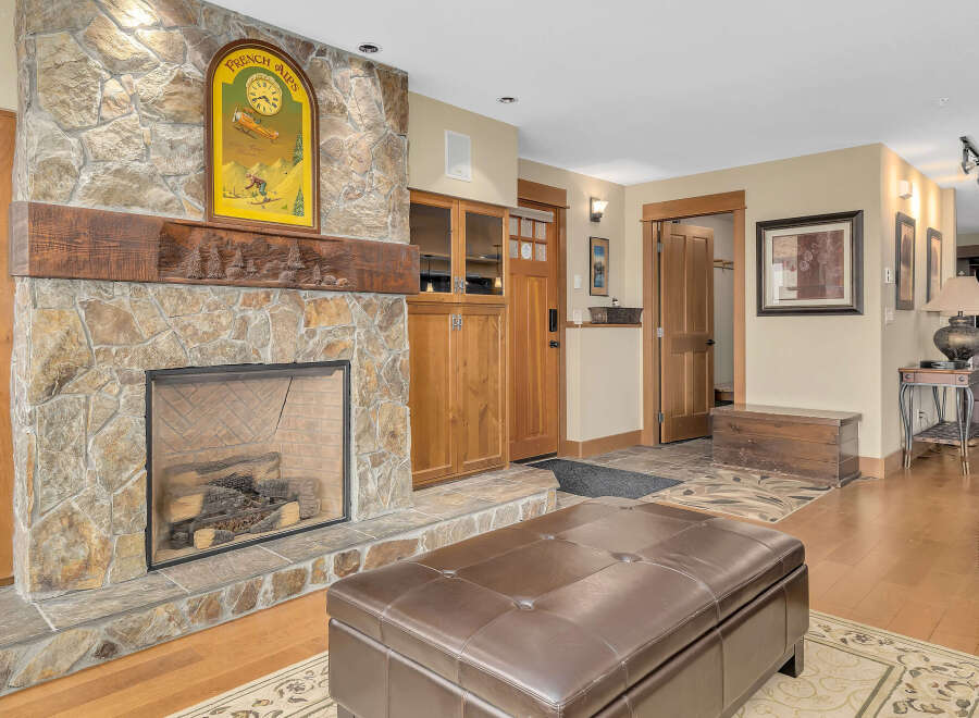 This stunning property boasts a cozy living space centered around a beautiful stone fireplace, perfect for those chilly evenings.