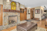This stunning property boasts a cozy living space centered around a beautiful stone fireplace, perfect for those chilly evenings.