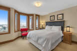 This cozy bedroom features a comfortable bed with crisp white linens, perfect for a relaxing retreat.