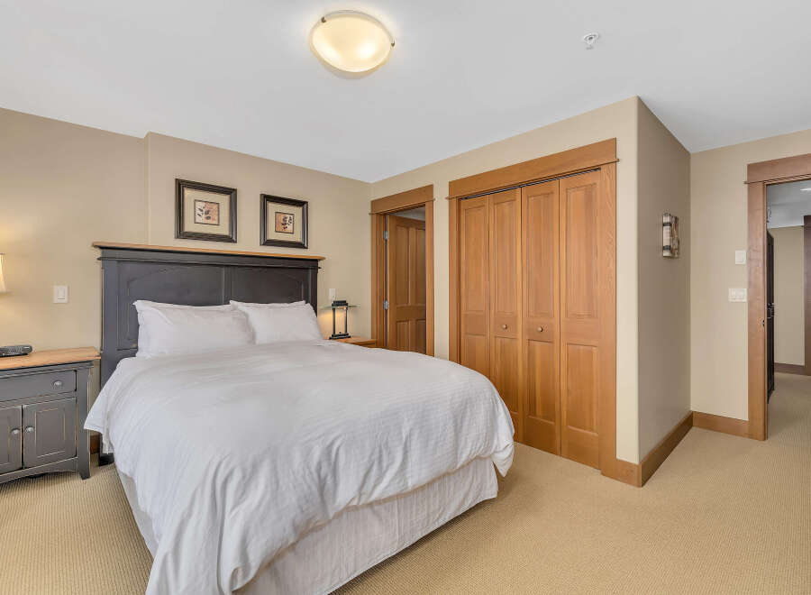 Step into this inviting bedroom, featuring a comfortable bed and ample storage.