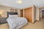 Step into this inviting bedroom, featuring a comfortable bed and ample storage.