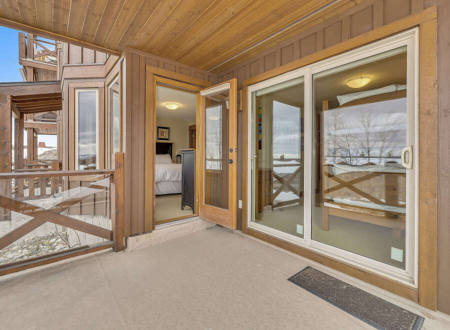 Step into luxury with this stunning property featuring a spacious outdoor patio and expansive glass doors.