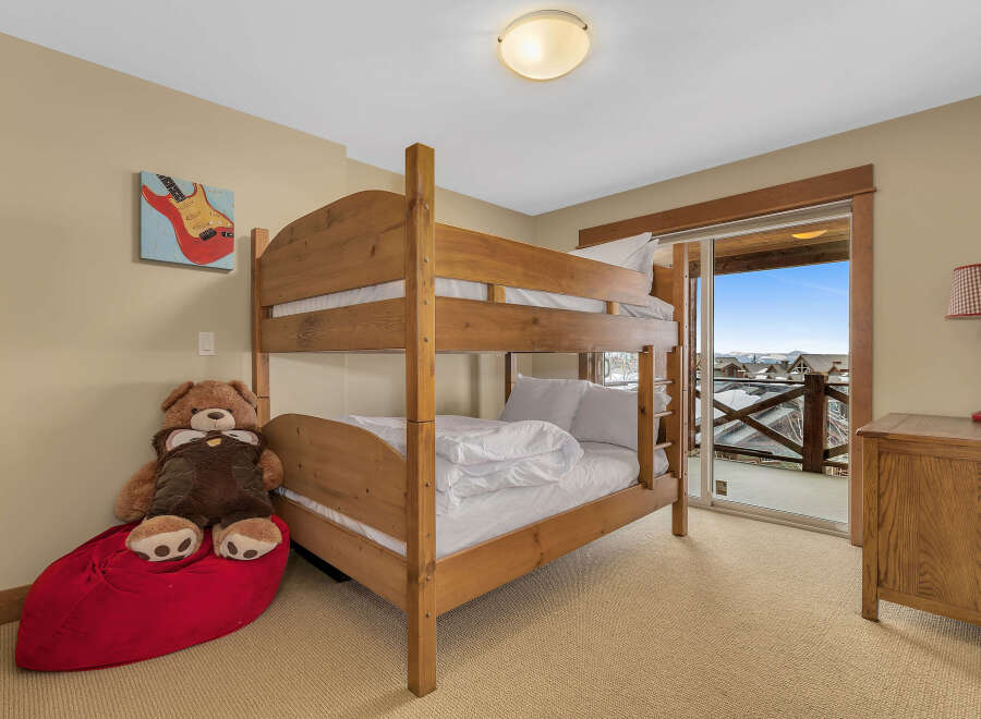 This charming bedroom features a cozy bunk bed, perfect for accommodating guests or family members.