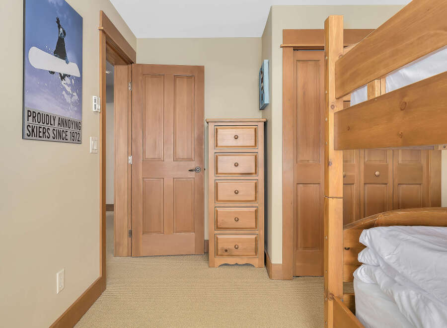 This cozy bedroom features a charming bunk bed, perfect for accommodating guests or family.