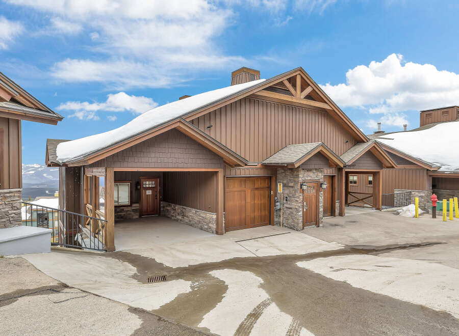This stunning property boasts a beautiful exterior with a combination of wood and stone accents, creating a warm and inviting atmosphere.