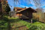 Discover this charming wooden cabin nestled in a serene natural setting.