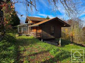 Discover this charming wooden cabin nestled in a serene natural setting.