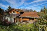 Discover this charming wooden house nestled amidst lush greenery.