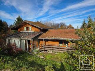 Discover this charming wooden house nestled amidst lush greenery.