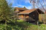 Discover a charming wooden chalet nestled in a serene natural setting.