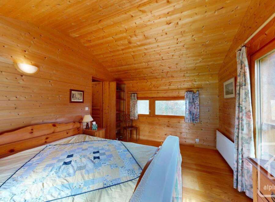 This charming wooden cabin bedroom offers a cozy and inviting atmosphere.