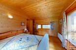 This charming wooden cabin bedroom offers a cozy and inviting atmosphere.