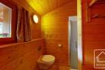 This charming bathroom features warm wooden paneling, creating a cozy and inviting atmosphere.