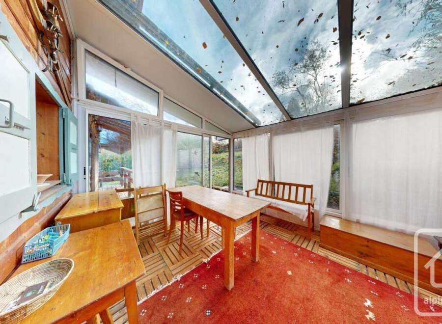 This charming property features a sun-drenched conservatory, perfect for enjoying the surrounding natural beauty.