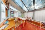This charming property features a sun-drenched conservatory, perfect for enjoying the surrounding natural beauty.