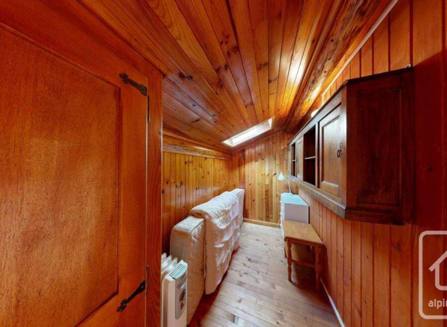Discover the charm of this cozy wooden-paneled room, perfect for a unique living space.