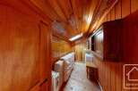 Discover the charm of this cozy wooden-paneled room, perfect for a unique living space.