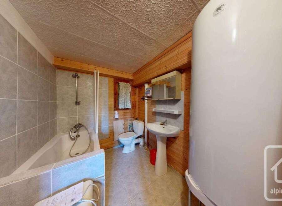 This charming bathroom features a combination of rustic wooden accents and modern amenities.
