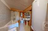 This charming bathroom features a combination of rustic wooden accents and modern amenities.