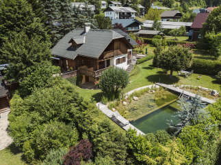 Discover your dream home in this stunning property! This luxurious house boasts a beautiful wooden exterior, a charming balcony, and a serene pond.