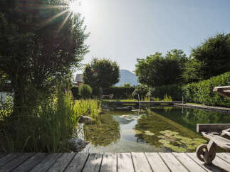 Escape to your own private oasis with this stunning property! Featuring a serene natural pool surrounded by lush greenery, this home offers a tranquil retreat.