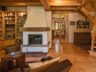 This stunning property boasts a cozy living space with a beautiful fireplace, perfect for relaxing evenings.