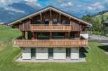 Discover the charm of this stunning wooden chalet nestled in a picturesque mountain setting.