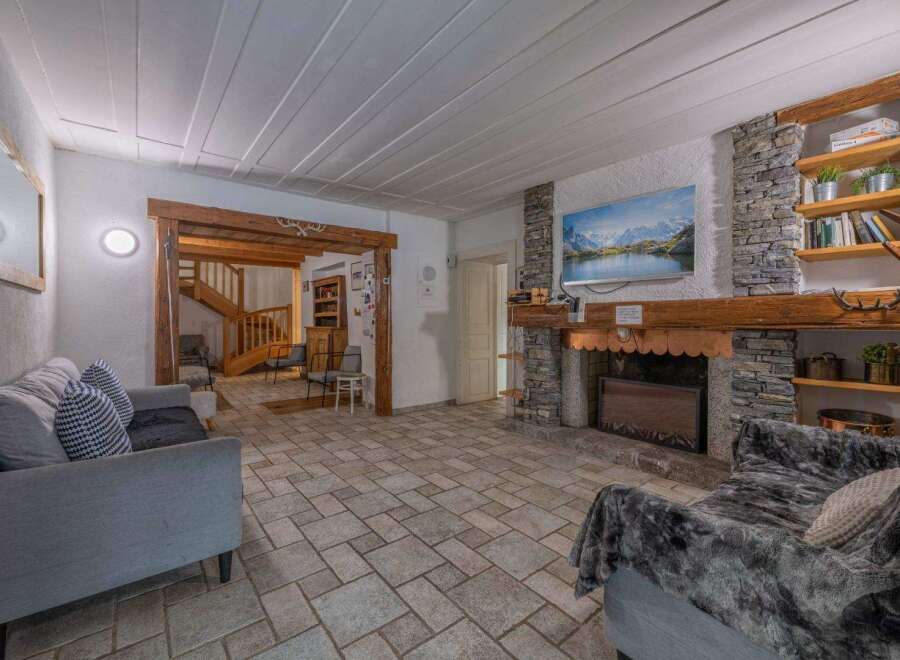 Step into this inviting living space, featuring a cozy fireplace and a stunning stone facade.