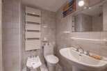 This charming bathroom features a classic design with tiled walls and a pedestal sink.