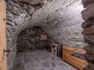 Discover the charm of this unique property featuring a rustic stone interior and a cozy atmosphere.