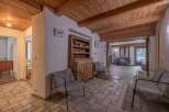 Step into this inviting home featuring a warm, wooden ceiling and a cozy seating area.