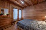 This charming bedroom features a rustic wooden interior, creating a warm and inviting atmosphere.