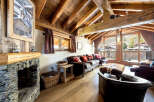 Experience the charm of this cozy mountain retreat, featuring a stunning stone fireplace and exposed wooden beams that create a warm and inviting atmosphere.