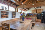 This charming property boasts a rustic dining area with a large wooden table and benches, perfect for gatherings.
