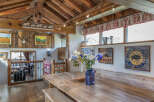 Step into rustic elegance with this stunning property, showcasing a beautifully crafted wooden dining area.