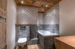 This stunning bathroom features a luxurious design with a combination of wood and tile elements.