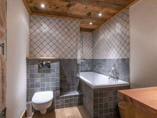 This stunning bathroom features a luxurious design with a combination of wood and tile elements.
