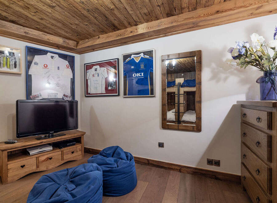 This cozy room features a rustic wooden ceiling and flooring, creating a warm and inviting atmosphere.