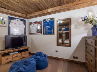 This cozy room features a rustic wooden ceiling and flooring, creating a warm and inviting atmosphere.