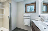 Experience modern luxury in this stunning bathroom, featuring a sleek glass shower enclosure and a spacious vanity with a clean white sink.