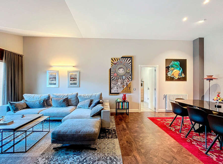 Discover modern living in this stylish property, featuring a spacious living area with a comfortable sectional sofa and a sleek coffee table.