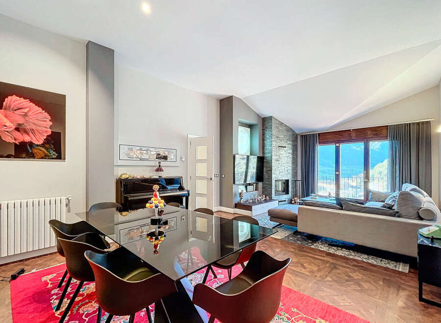 Experience luxury living in this stunning property! This home boasts a modern design with a sleek black dining table and comfortable seating.